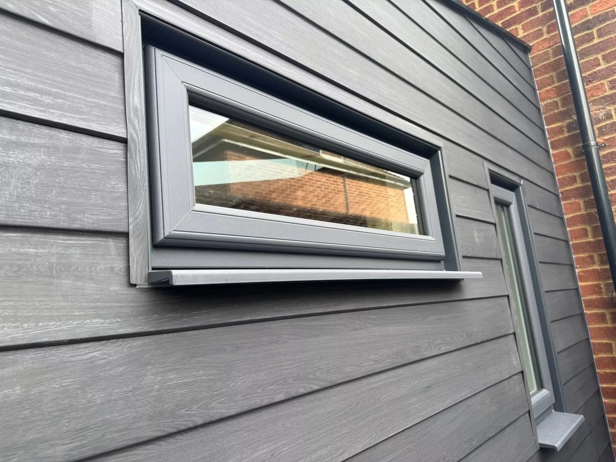 Close view of the finished dark cladding and new window detailing