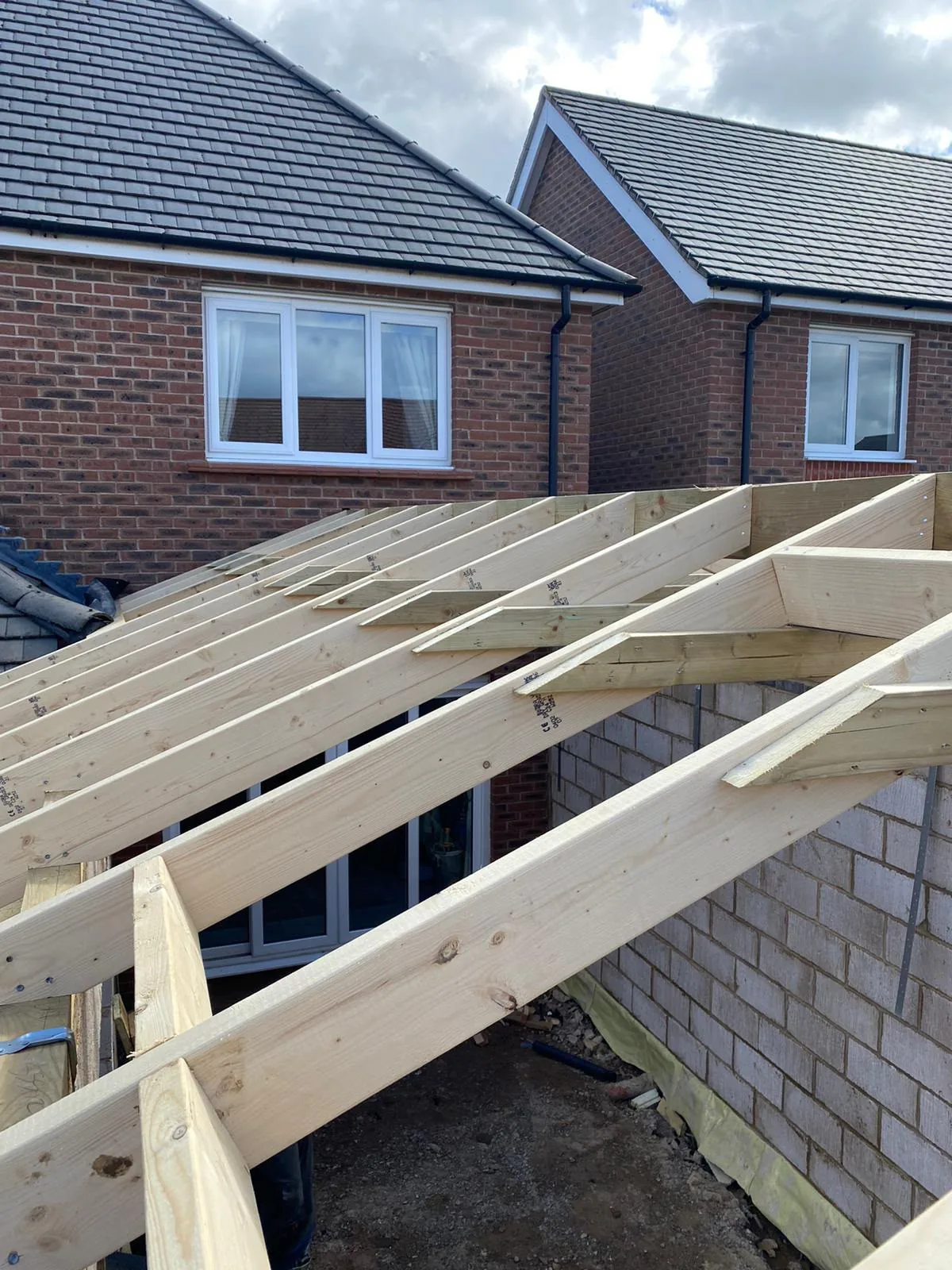 Timber roof structure being installed over the new extension