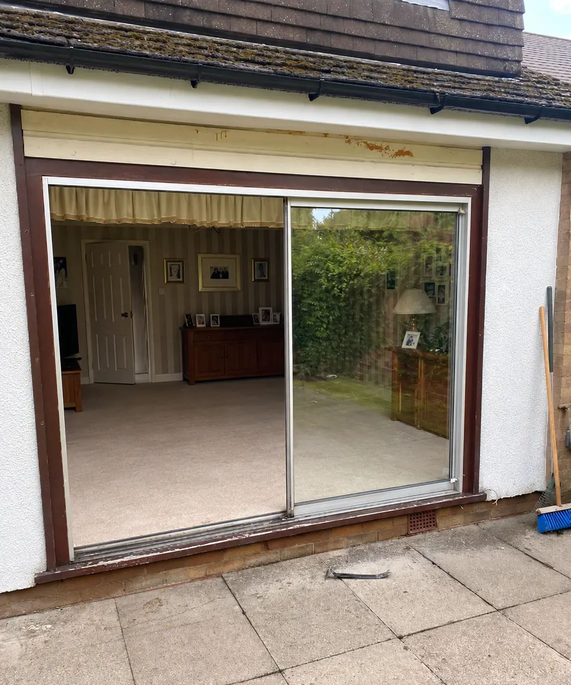 Kettering home before replacement, with ageing sliding patio doors and surrounding trim