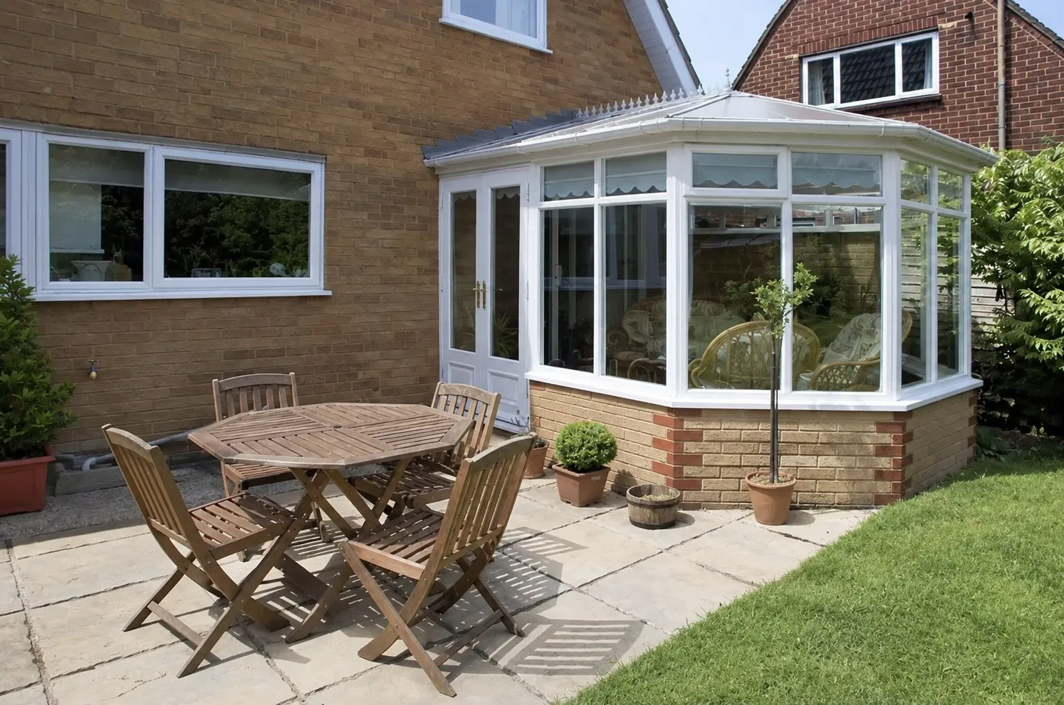 White Victorian conservatory with a faceted bay frontage