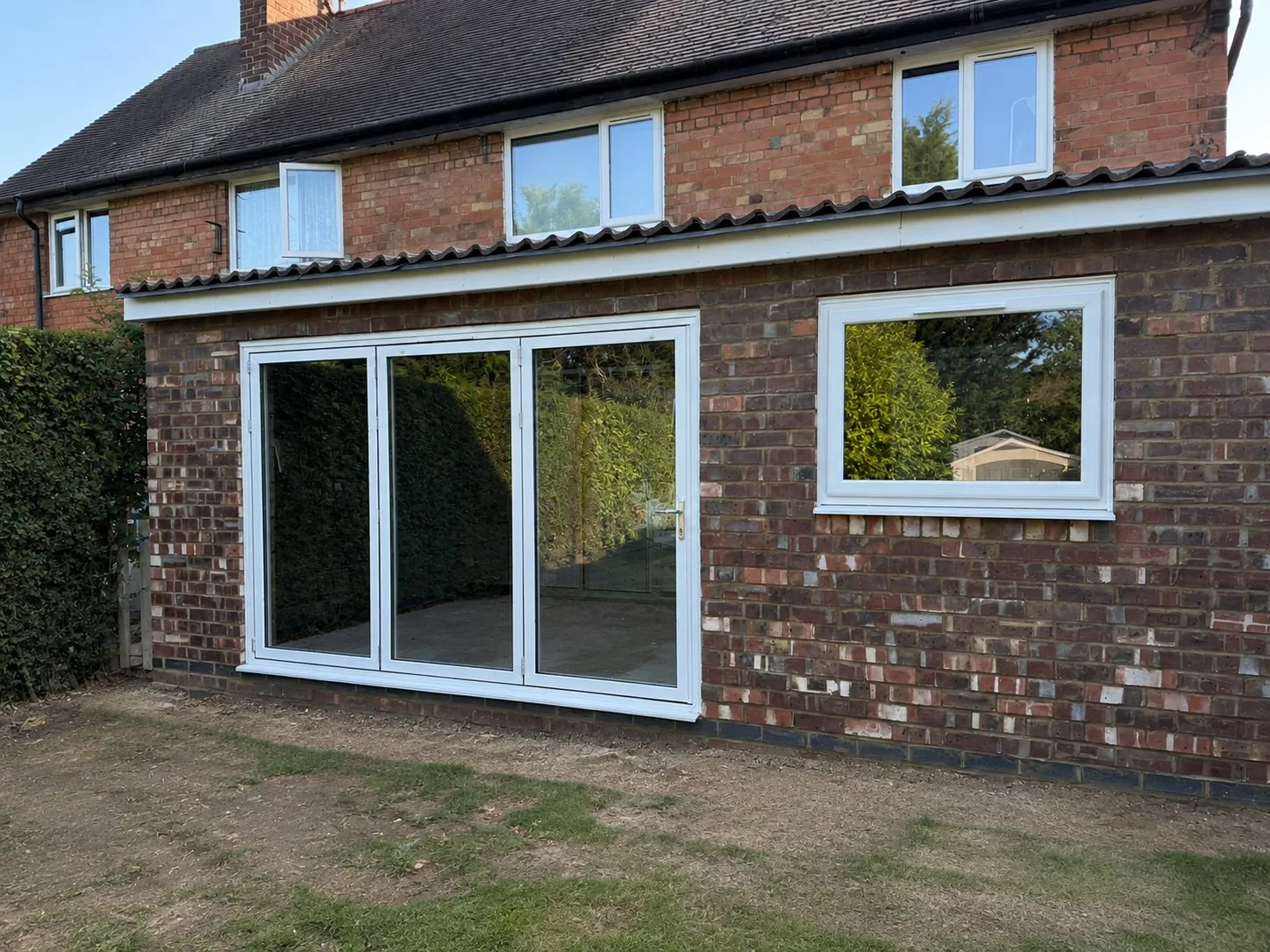 Brick-built single-storey extension with glazed doors and a new window