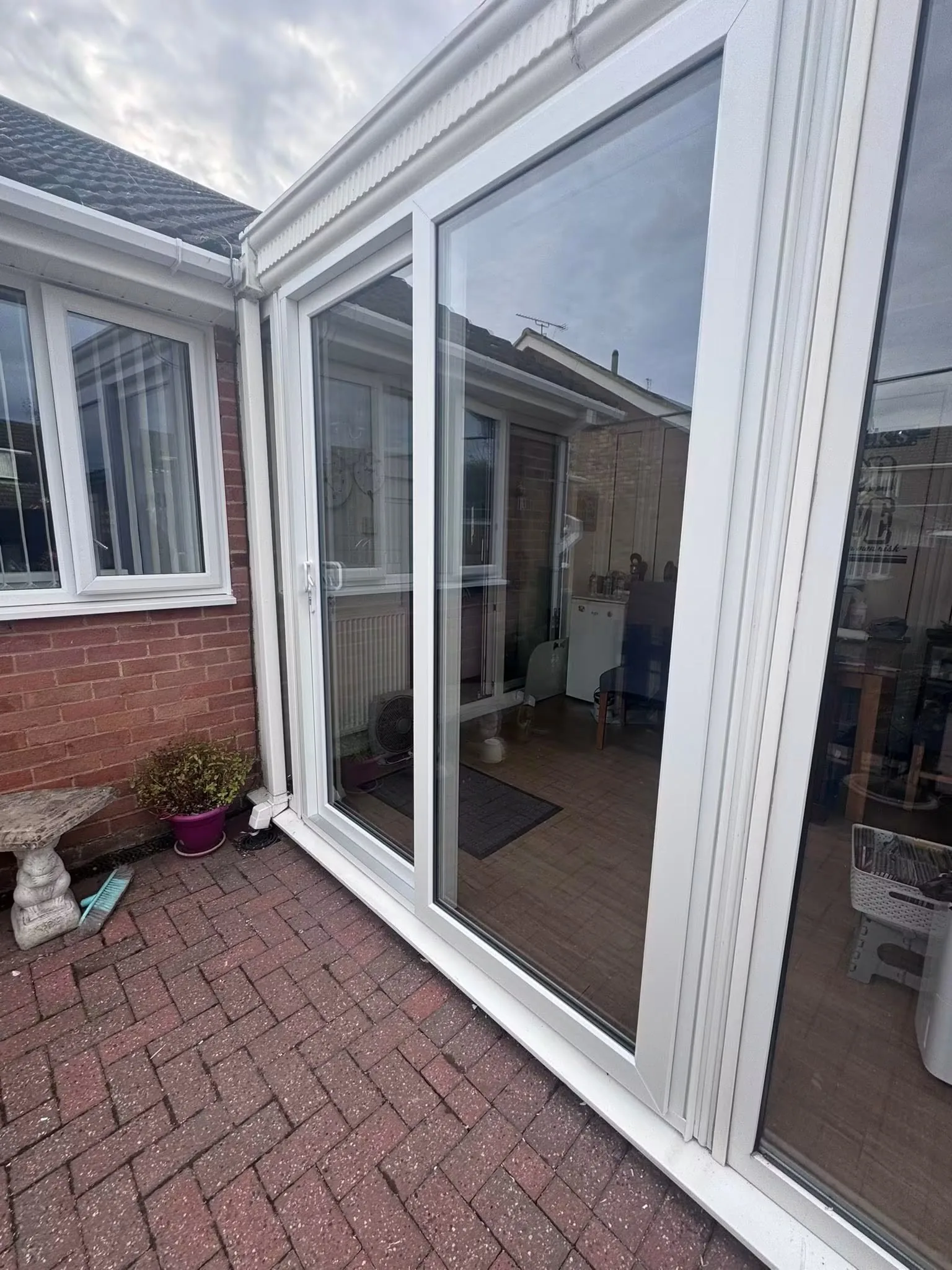 White sliding patio door installation showing the handle, frame and running track